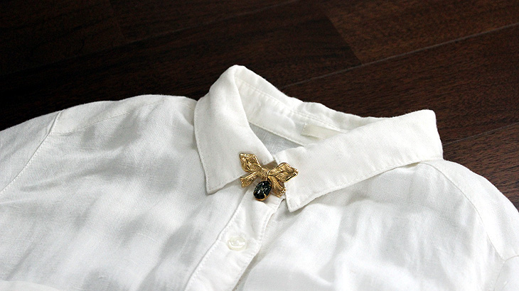 image-of-attaching-a-brooch-to-a-shirt