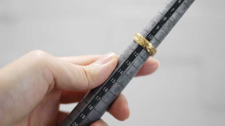A photo of a stick measuring the size of a ring